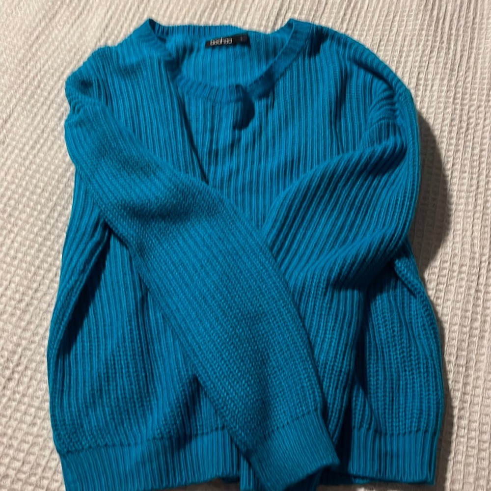 Thin sweater is a turquoise color